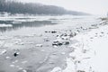 River with ice drifting and bare forest visible on other side Royalty Free Stock Photo