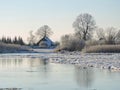 River Atmata , homes and snowy trees , Lithuania Royalty Free Stock Photo