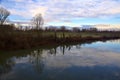 River in the italian countryside in winter with the sky casted in the water Royalty Free Stock Photo