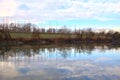 River in the italian countryside in winter with the sky casted in the water Royalty Free Stock Photo