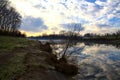 River in the italian countryside in winter with the sky casted in the water Royalty Free Stock Photo