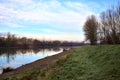 River in the italian countryside in winter with the sky casted in the water Royalty Free Stock Photo