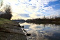 River in the italian countryside in winter with the sky casted in the water Royalty Free Stock Photo