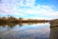 River in the italian countryside in winter with the sky casted in the water Royalty Free Stock Photo