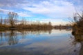 River in the italian countryside in winter with the sky casted in the water Royalty Free Stock Photo