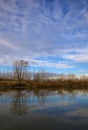 River in the italian countryside in winter with the sky casted in the water Royalty Free Stock Photo