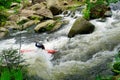 River kayaker going over waterfall in the forest