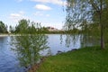 River or lake water and green grass and building Royalty Free Stock Photo