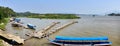 River landscape of the Mekong river. Boats and a wooden pier on the river. Golden Triangle. Border with Myanmar and Laos along the
