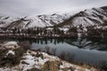 River landscape powdered by snow. Snowy hills reflect in calm water of Snake river. Hells canyon area Royalty Free Stock Photo