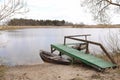 River landscape in the summer with wooden bridge and wood old Fishing boat near riverbank. natural background. selective focus Royalty Free Stock Photo