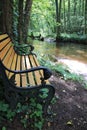 The river Lauter in Alsace France with romantic place in wood with a bench