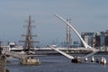 River Liffey in Dublin, Ireland. Jeanie Johnston ship, Samuel Becket Bridge and Poolbeg chimneys Royalty Free Stock Photo