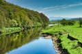 The River Lune near Lancaster flowing through lush green country Royalty Free Stock Photo