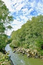 River with a rocky channel and green vegetation