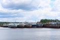 River with many rusty cargo ships and sky with clouds