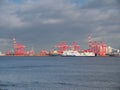 On the River Mersey the Stena Ferry passes the container handling cranes of the Port of Liverpool