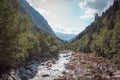 River in the middle of a valley surrounded by trees