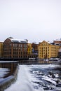 The river Motala Strom (Strommen) by old industrial buildings, a landmark of Norrkoping, Sweden in winter Royalty Free Stock Photo