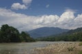 River with mountains and clouds in background