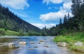 River in mountains with rocks, green grass on riverside. Mountain landscape, beautiful sky, clouds. Idea for outdoor activities, Royalty Free Stock Photo