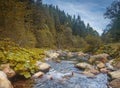 River in mountains with rocks, yellow grass on riverside. Autumn mountains landscape, sky, clouds. Idea for outdoor activities, tr