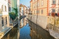 River between old houses with flowers with reflection in autumn