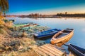 River and old wooden rowing fishing boat at beautiful sunrise in Royalty Free Stock Photo