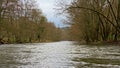 River Ourthe with bare winter trees on the shores Royalty Free Stock Photo