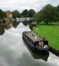 The river Ouse at St Neots with narrow boat, park and riverside properties.