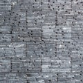 River pebble wall tile background natural texture cross-section cut structure design in dark black grey Royalty Free Stock Photo