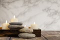 River pebbles and four lighted candles Royalty Free Stock Photo