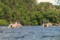 River pontoon parade passes a home in Eau Claire Wisconsin