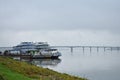 River port berth cruise ships boat dock, away bridge, fog low Royalty Free Stock Photo