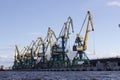 The river Port cranes load coal into railway.