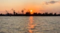 River port with ships at sunset. Busy traffic artery. Logistics and infrastructure. Loading and unloading of ships, trade traffic Royalty Free Stock Photo