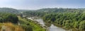 River with rapids and stones outcrops, banks overgrown with trees Royalty Free Stock Photo