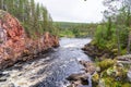 river and red wall of canyon Kiutakongas rapids in Oulanka National Park, edge of the forest Royalty Free Stock Photo