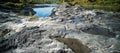 River with rocks in the foreground and reflection of fall scenery Royalty Free Stock Photo