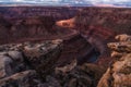 a river runs through an eroded out canyon near a mountain