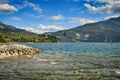 river Sarca flows into lake garda, Riva, Nago, Torbole. landscape with water, mountains, blue sky Royalty Free Stock Photo