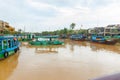 River scene with transportation boats moored to wharves and sailing