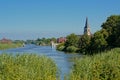 river Scheldt landscape with church tower in the flemish countryside