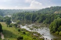 River section with rapids and stones outcrops, forested hilly banks Royalty Free Stock Photo