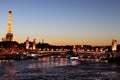 River Seine Paris by night with Alexandre III bridge and Eiffel Tower illuminated france