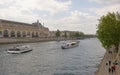 On the river Seine sailing ships with tourists. Pedestrians wal