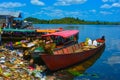 River with simple boats for passenger transportation. Garbage dropped on beach, dirty water