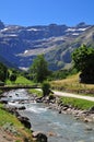 River with a small bridge against the background of mountains. Cirque de Gavarnie, France. Royalty Free Stock Photo