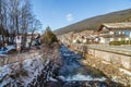 river through snowy alpine village Royalty Free Stock Photo