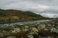 river stream going through stones and hills on field, Norway, Hardangervidda Royalty Free Stock Photo